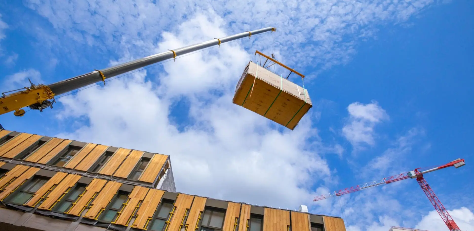 Modular construction crane installing structural elements